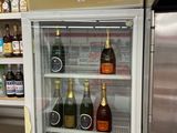 a refrigerator with a lot of bottles of alcohol inside of it