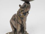 an image of a statue of an elephant with a hat on it ' s head