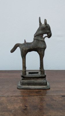 a statue of a horse that is on a wooden table