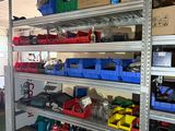 many different types of tools on the shelves in the garage