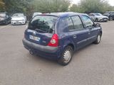 a blue car that is parked in a parking lot
