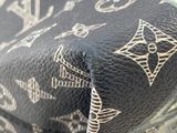 a close up of a louis vuitton bag on a table