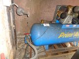 a blue air compressor sitting on a pallet in a room