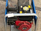 a small red and black engine on a blue cart