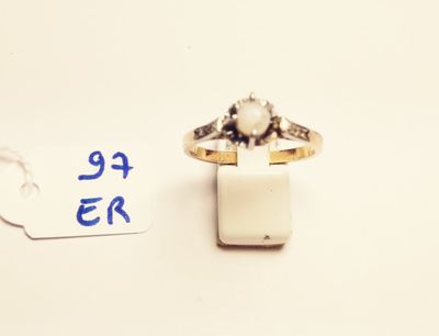 a small ring with a stone in it and a price tag