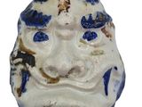 a blue and white ceramic mask with a cat ' s face