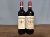two bottles of wine sitting on a wooden table
