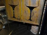two wine glasses painted on the side of a wooden cabinet