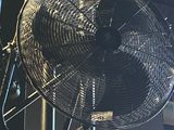 a fan that is hanging from the ceiling of a building