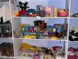 a white bookcase filled with toys and other items