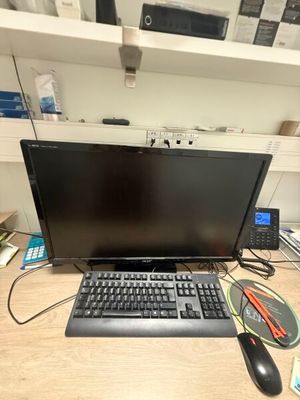 a laptop computer sitting on a desk with a keyboard and mouse