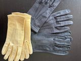 two pairs of gloves sitting on top of a black table