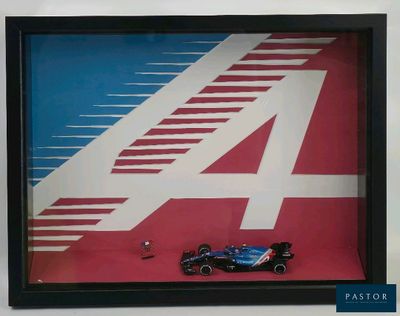 a picture of a picture of a racing car in a shadow box