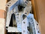 many pieces of metal in a cardboard box on the floor