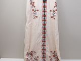 an image of a dress hanging on a hanger on a wall