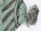 a knitted hat with a tassel on top of it