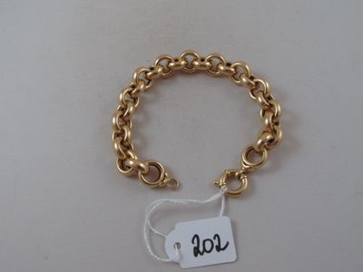 a close up of a gold bracelet with a tag on it