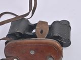 an old pair of binoculars sitting on a white surface
