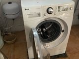 a washer and a toilet in a small room