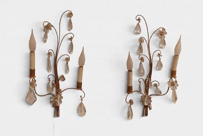 pair of wall sconces with flowers and leaves on each of them
