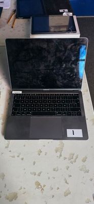 a laptop computer sitting on a table in a room