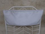 an image of a white laundry basket on a metal rack