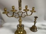 a brass candelab with a figurine on top of it