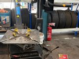 a car being worked on by a mechanic in a garage