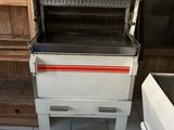 a white stove with a red stripe on it in a kitchen