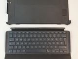 two laptops are sitting on a white surface with one open and the other closed