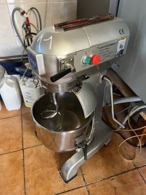 a mixer that is sitting on the floor in the kitchen