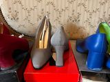 several pairs of women ' s shoes are sitting on a red box