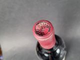 a bottle of wine that has a red label on it