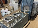 two metal containers sitting on top of a pallet in a warehouse
