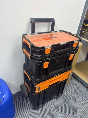 three black and orange boxes stacked on top of each other