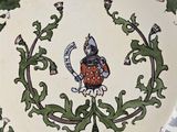 a decorative plate with a picture of a knight on it