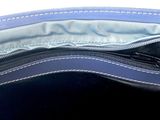 a blue purse with a zipper on the inside of it