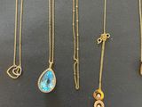 a collection of gold necklaces and pendants