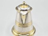 an image of a silver and gold bell on a white surface