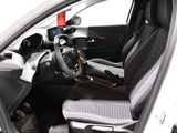 the interior of a small car with a steering wheel and a dashboard