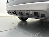 a close up of a car ' s bumper with a small hole in it