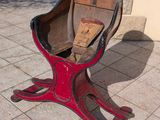 a wooden sled sitting on the ground in front of a building