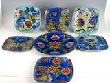 six pieces of blue and orange plates with flowers on them