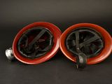 pair of red and black fire hydrants on a black background