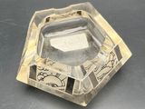 a clear glass ashtray with a picture of a cat on it