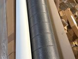 two rolls of black and white tape sitting on top of a cardboard box