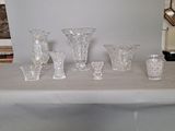 a table with a bunch of glass vases on top of it
