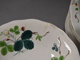 many plates with different designs on them sitting on a table