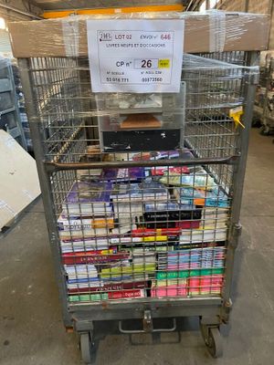 a metal cart with many items in it in a warehouse