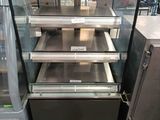 a display case with a lot of food inside of it
